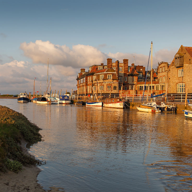 Blakaney Quay with boats and Blakeney Hotel