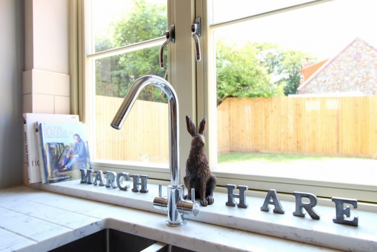 March Hare letters and bronze hare in kitchen window 