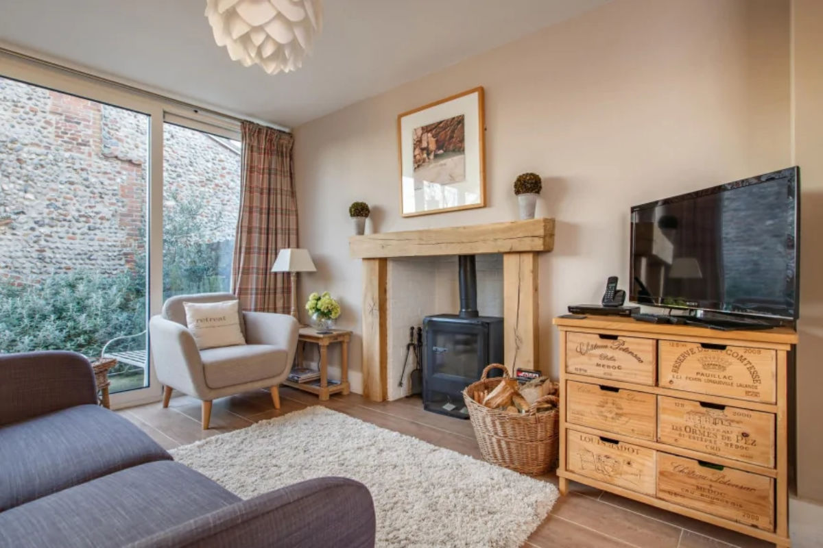 The Retreat sitting room with TV and woodburner