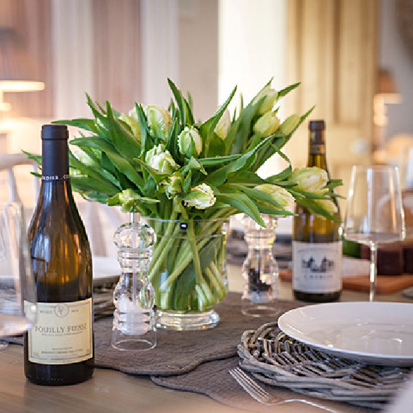 Table laid with flowers and wine